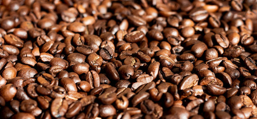 the surface is completely covered with roasted coffee beans; wallpaper, banner, background