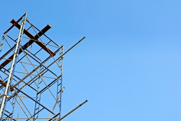 Construction scaffolding. Copy space with blue sky background. Industrial and construction concept.