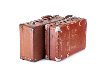 two leather brown aged vintage suitcases isolated on white - obrazy, fototapety, plakaty