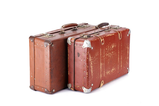 Fototapeta two leather brown aged vintage suitcases isolated on white