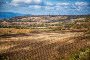 Beauty rural landscape of a clean plowed field and small village