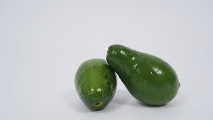  Avocado and full avocado on white background.