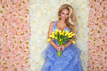 Fashion wedding dress model with a bouquet of tulips. Beautiful bride model in blue amazing wedding...
