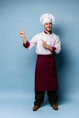 Chef presenting something over light blue background