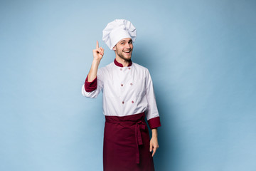Chef presenting something over light blue background