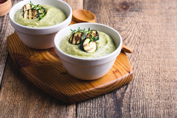 Healthy zucchini cream soup in ceramic bowls