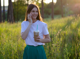 A young girl with a coffee cocktail. Summer image.