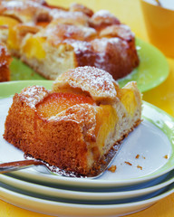 Piece of peach cake on a plate. Close up