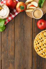 Baked apple pie and ingredients on wooden table. Seasonal pastry