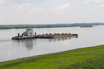 Fototapeta na wymiar barge with sand on the Irtysh River