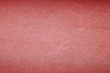 Plastic glittering texture with blur effect in red color.