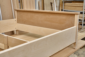 Bed building process. Wooden furniture manufacturing process. Furniture manufacture. Close-up