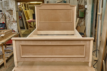 Obraz na płótnie Canvas Bed building process. Wooden furniture manufacturing process. Furniture manufacture. Close-up