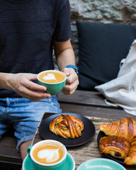 Mug of coffee in hands. Atmospheric photo in a coffee shop.