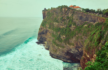 Uluwatu Temple on a cliff near the ocean.