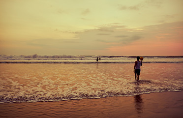 Fototapeta na wymiar People on the beach at sunset. Bali.