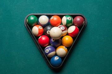 Old billiard balls on a green table. billiard balls isolated on a green background