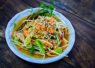 Somtum Thai food on a brown table