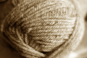 Yarn ball close-up with blur effect in brown tone.