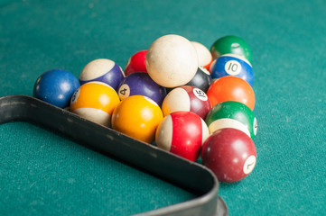 Old billiard balls on a green table. billiard balls isolated on a green background