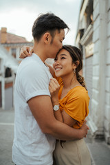 Young Asian couple hugging each other at sunset in the summer in Venice, Italy