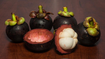 Tropical fruits mangosteen on the wooden table