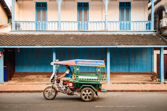 Colonial building and Tuk Tuk Skylab on Luang Prabang street, Laos
