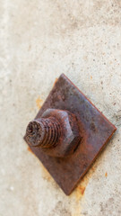 Rusty bolt with a nut in the mounting post is close