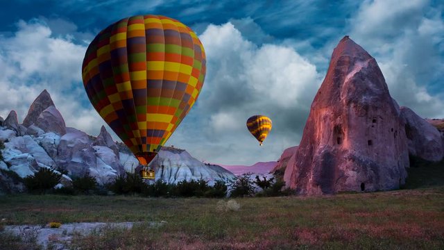 Cinemagraph of fairy chimneys in Cappadocia, Turkey, with balloons set against dynamic cloud motion.