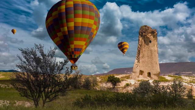 Cinemagraph of fairy chimney in Cappadocia, Turkey, with balloons set against dynamic cloud motion.
