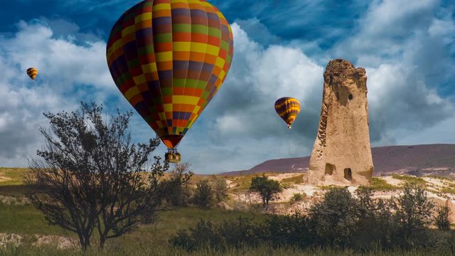 Cinemagraph of fairy chimney in Cappadocia, Turkey, with balloons set against dynamic cloud motion.