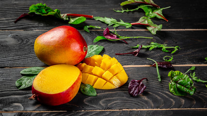 Mango tropical fruit on a dark wooden background. Flat lay. place for text. Food concept