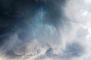 Obraz premium Gloomy scary rain clouds in the blue sky.