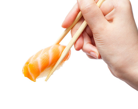 chopsticks hold sake nigiri sush with salmon