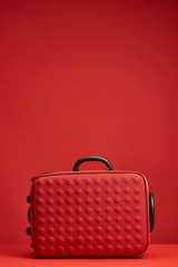 red colorful textured travel bag isolated on red with copy space
