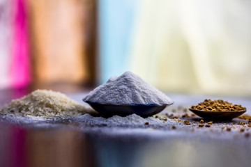 Hair growth remedy of rice flour water and fenugreek seed powder on wooden surface.