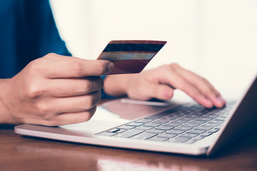 Happy Asian woman shopping online and paying by credit card.technology and ecommerce concept
