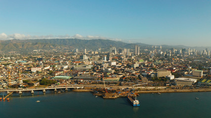 Aerial view of panorama of the city of Cebu with skyscrapers and buildings during sunrise. Philippines.
