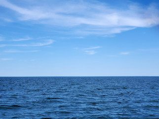 calm Lake Michigan blue water with horizon and summer sky