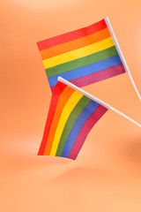 Fototapeta premium LGBT flag on orange background. Copy space.