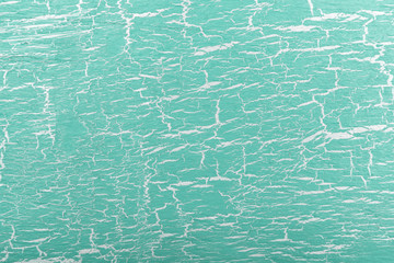 Abstract white and green painted cracked background.