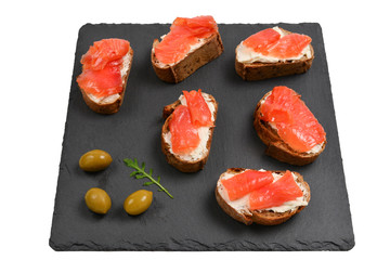 Salmon on a bread with cream isolated on white.