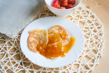 Pancakes with jam and strawberries