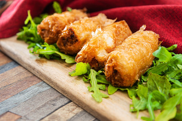 4 pork spring rolls Rice cakes stuffed with a pork stuffing accompanied by sauce