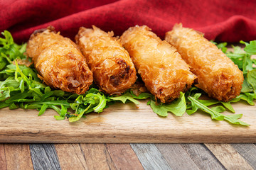 4 pork spring rolls Rice cakes stuffed with a pork stuffing accompanied by sauce