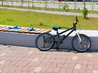 Obraz premium children's bike parked in the Park near the bench