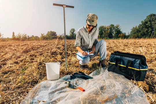 Soil Test. Female Agronomist Taking Notes In The Field