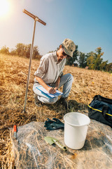 Soil Testing. Female Agronomists Taking Notes Outdoor