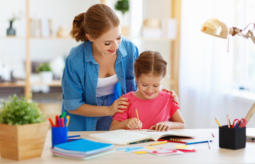 Fototapeta premium mother and child daughter doing homework geography with globe .