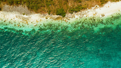 Tropical sandy beach with wave and turquoise water,copy space for text, aerial view. Ocean with waves and tropical beach. Summer and travel vacation concept